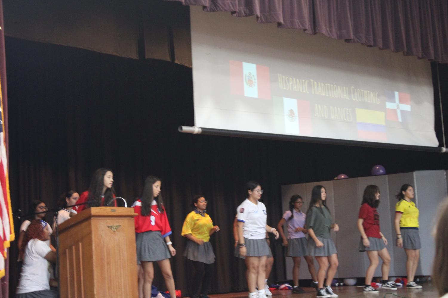 Students performing a dance to multiple songs during the assembly.