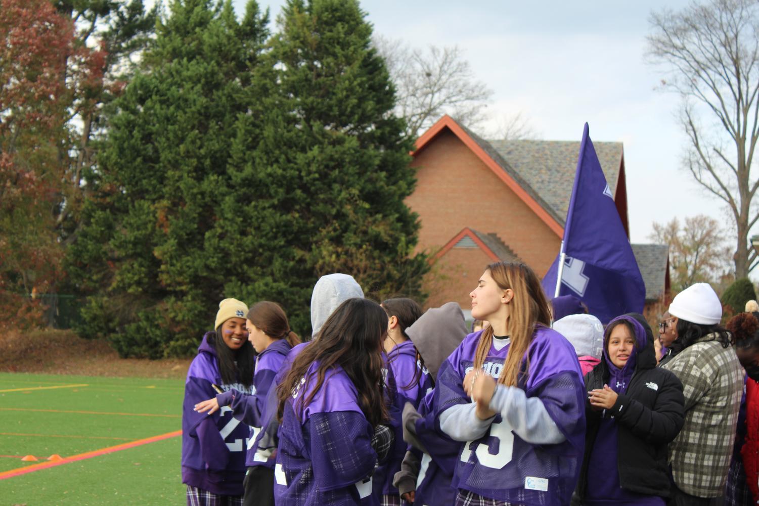 Seniors and sophomores cheering for the Purple Team.