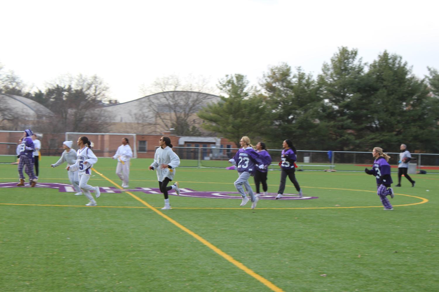 Juniors and seniors running down the field.