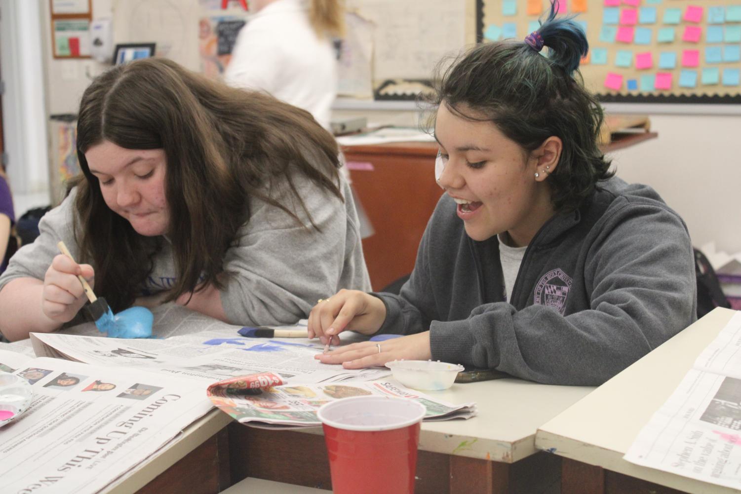 Katie Sheetz and Isabella Grijalba painting rocks together during Kindness Week.