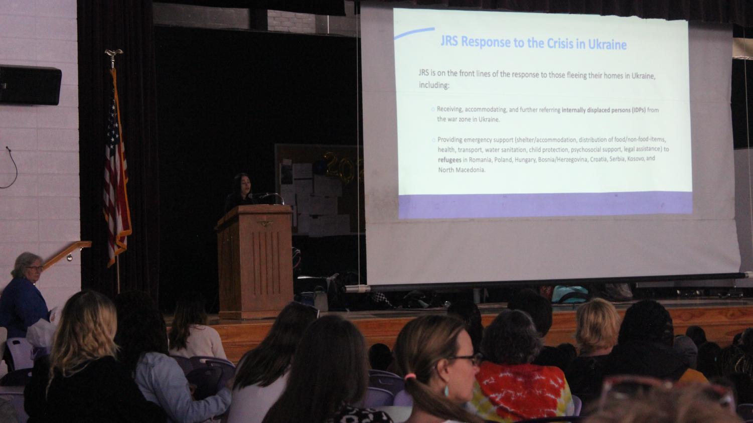 Alumna, Giulia Campanaro McPherson '95, speaks at the all school assembly about relief efforts in Ukraine.