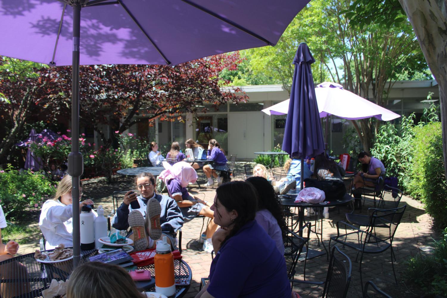 Students enjoy some outdoor seating as they enjoy the warm weather.