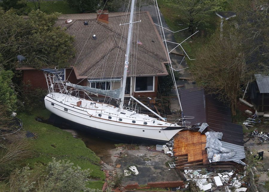 A+sailboat+is+shoved+up+against+a+house+and+a+collapsed+garage+Saturday%2C+Sept.+15%2C+2018%2C+after+heavy+wind+and+rain+from+Florence%2C+now+a+tropical+storm%2C+blew+through+New+Bern%2C+N.C.+