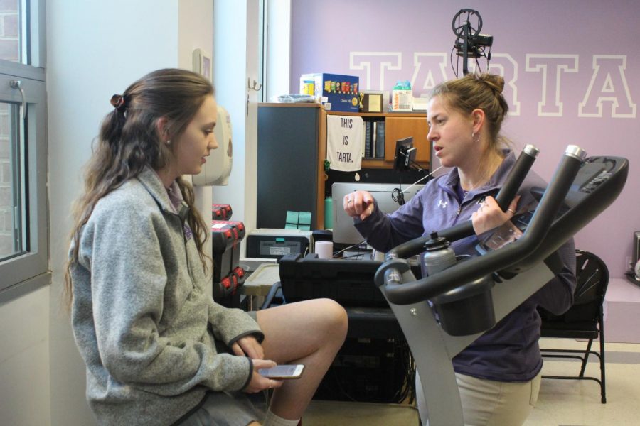 Athletic+trainer+Beth+Hagler+chats+with+junior+Kristen+Puglisi+about+her+recent+softball+injury.