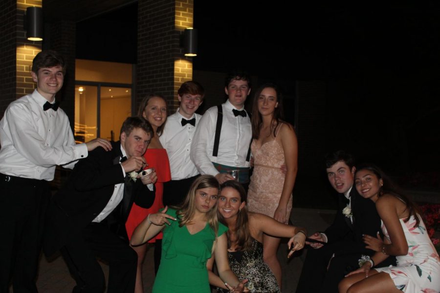 Juniors pose with their dates while they enjoy the ice cream sundaes in the courtyard.