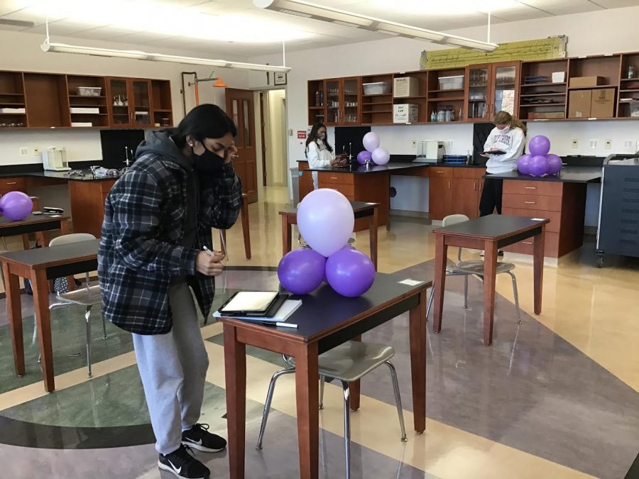 Sophomores completing a balloon atom lab.