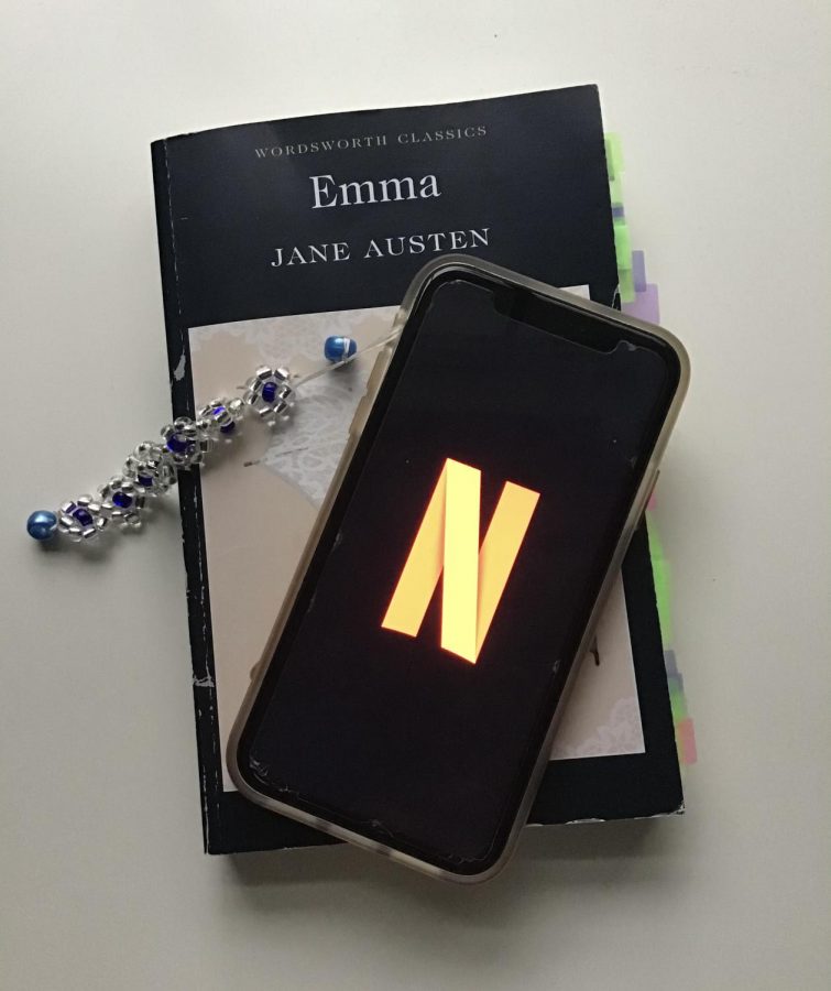 A phone with the Netflix logo and a book.