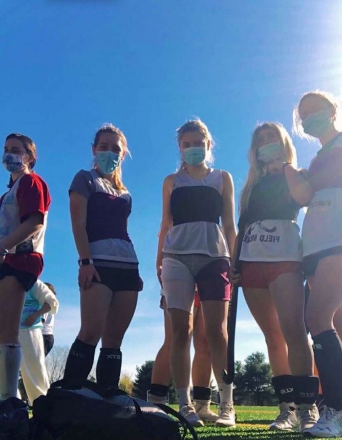 Some AHC field hockey players using the mask given as tube tops, while wearing their actual masks. 