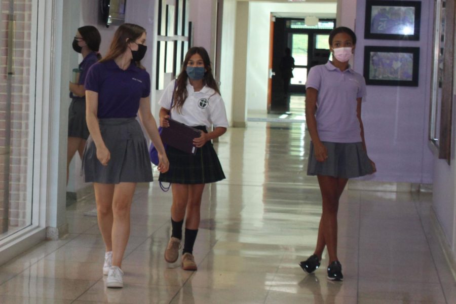 Students walking down the hall of school.
