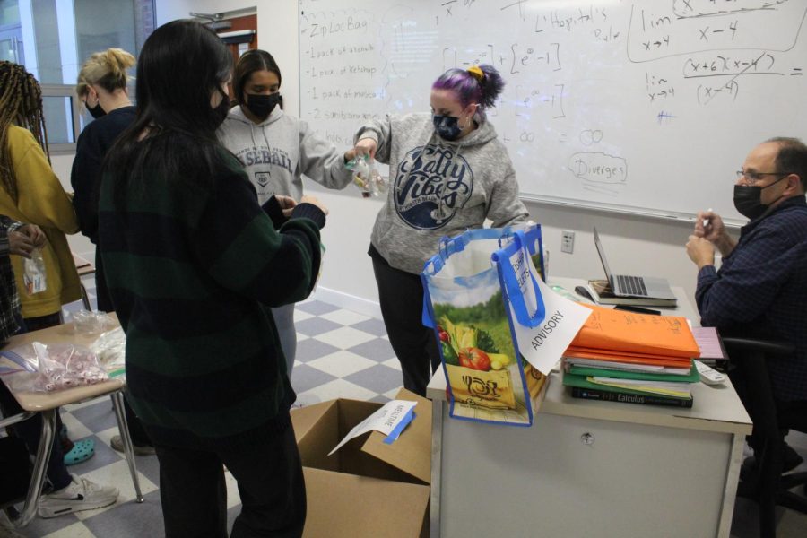 Students preparing bags for Holy Cross Gives Thanks