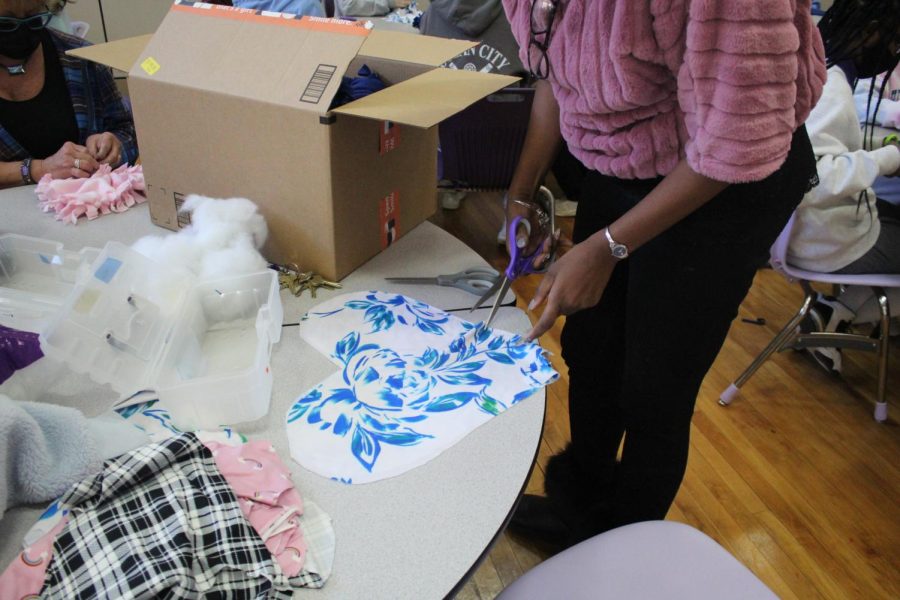 A teacher making heart pillows for breast cancer patients 