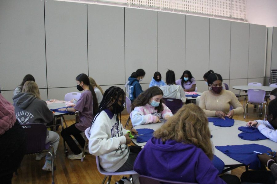 Students making heart pillows for breast cancer patients 
