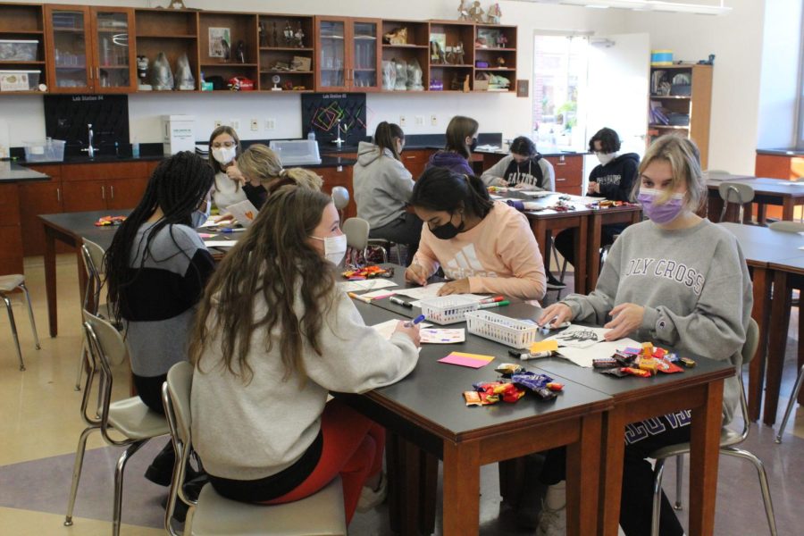 Students in a science room making cards