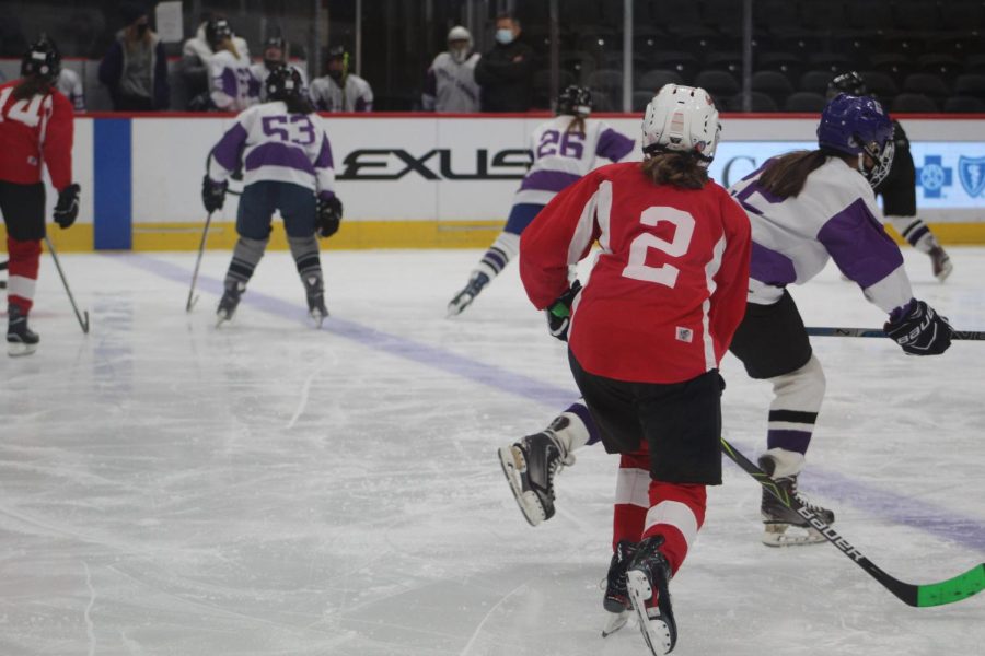 a group of players rushing to take possession of the puck