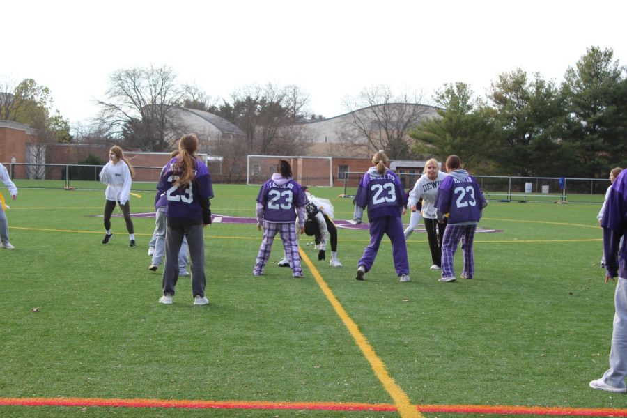 Holy Cross students playing flag football on the turf at the PowderPuff game this past fall. 