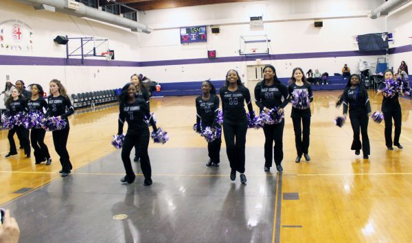 Varsity poms performing during the halftime of a Holy Cross basketball game.