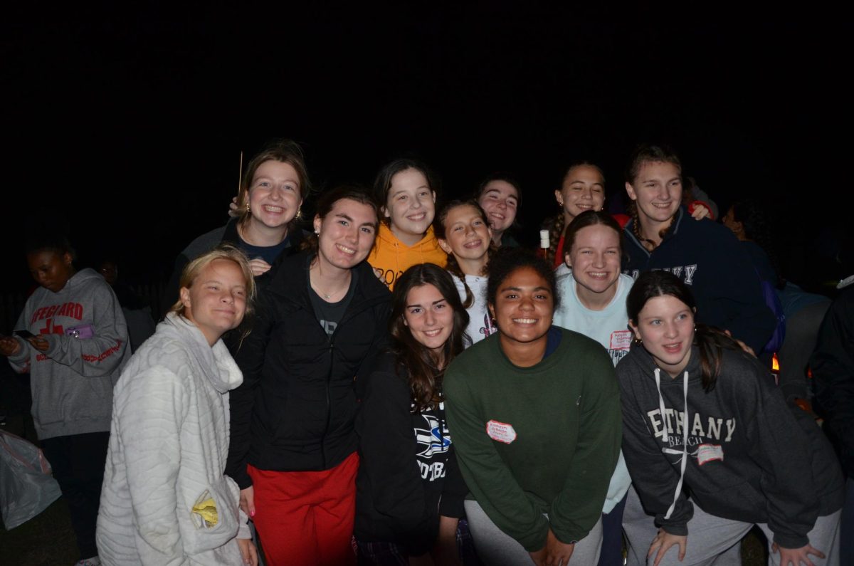 Students on Junior Retreat at Camp Wabanna happily gather at the campfire after a long day of activities. The juniors enjoy their time making smores, talking to eachother, and saying prayers of the rosary as a class. 