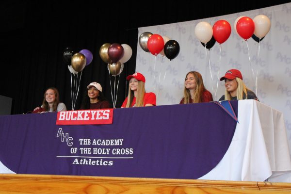 Seniors Mary Mongelli, Jaylyn Simon, Emmi Sellman, Meredith Dunsmore, and Mae Zaremba in the auditorium on signing day 2024. After years of hard work, their efforts paid off.