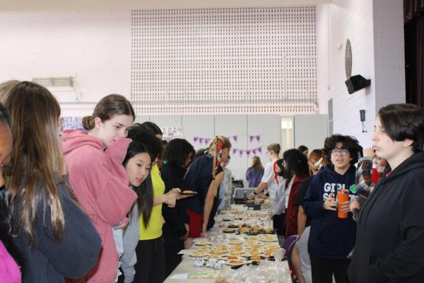 Students browse the International Bake Sale table during lunch. Proceeds from the sale are donated by the social justice department.