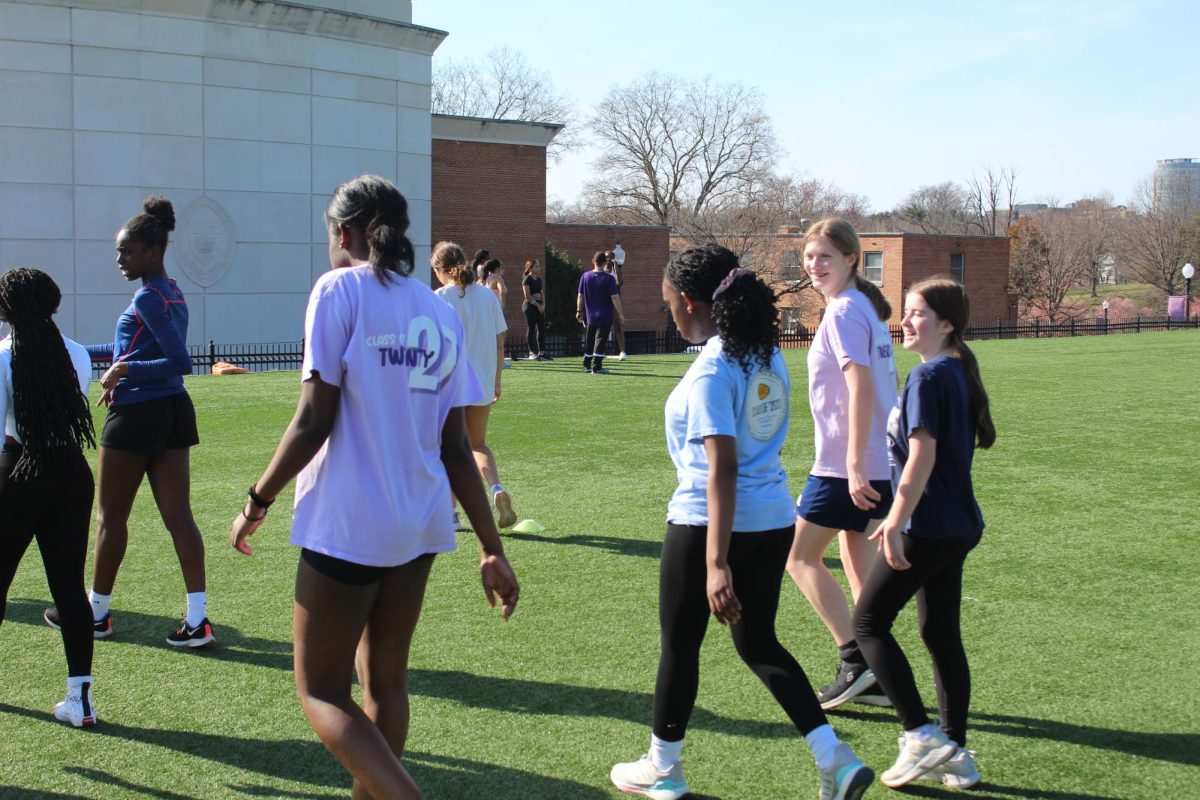 Freshmen+short+sprinters+Cecelia+Zarrelli%2C+Daniella+Quartey%2C+Salome+Nyangaya%2C+and+Blythe+Batchelder++walking+back+to+the+end+of+the+field+to+continue+practicing+for+upcoming+track+meets.+