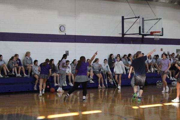 Mr Christian and Freshmen Alissa Umanzor celebrating after their team got a turnover during the tartan time basketball game. 