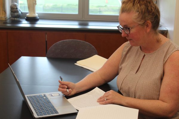 Madeleva Scholars Program coordinator Megan Minogue reviews a students research paper.