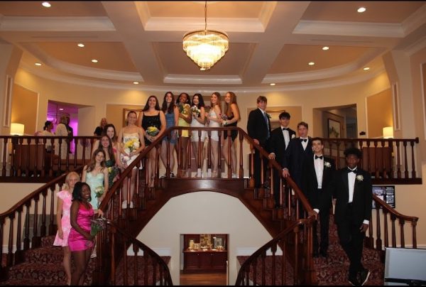 A group of girls and their dates taking formal photos.