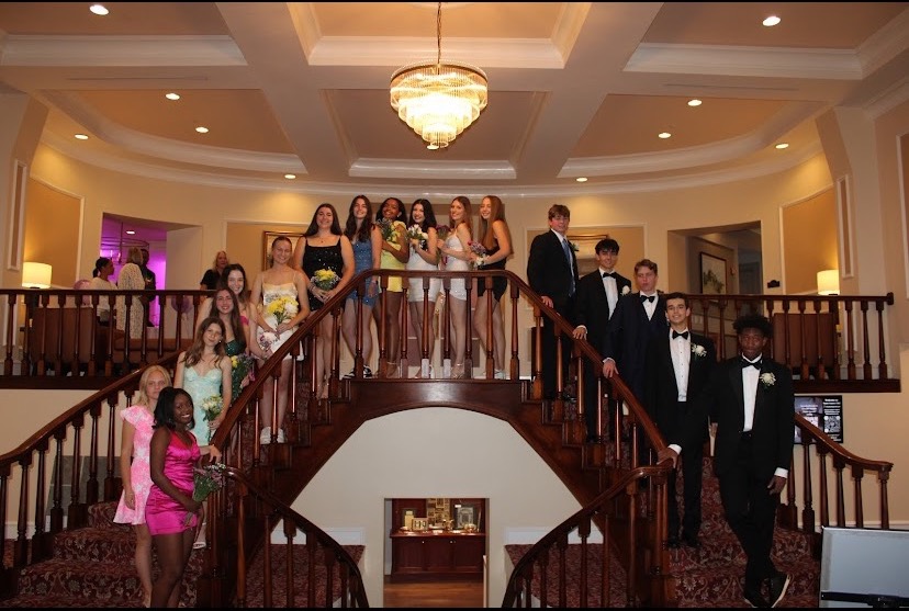 A+group+of+girls+and+their+dates+taking+formal+photos.