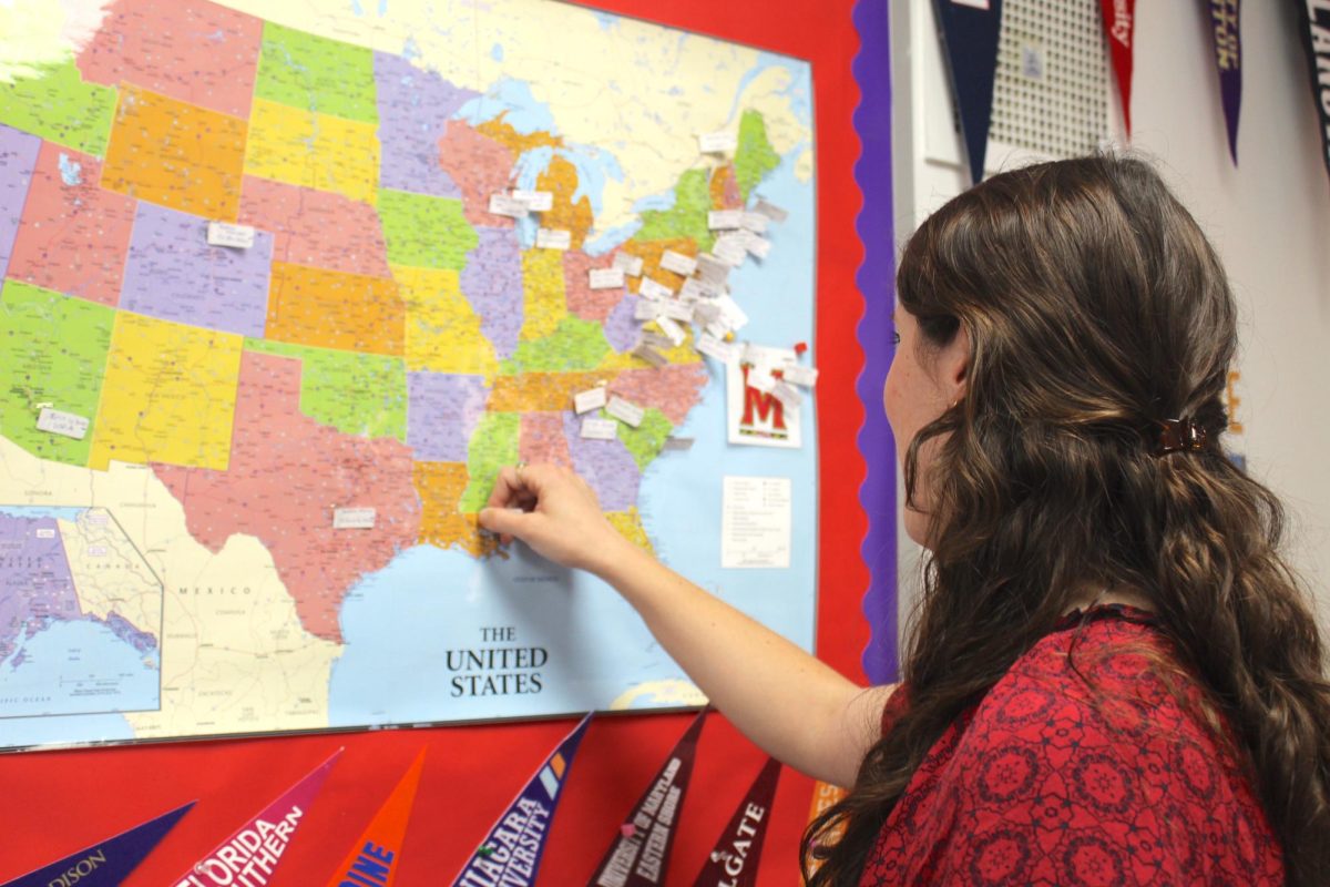 College counselor Shannon Donaldson looks over the map of colleges that the class of 2024 committed to. College Counselors assist students from their junior years up until they commit to their colleges.